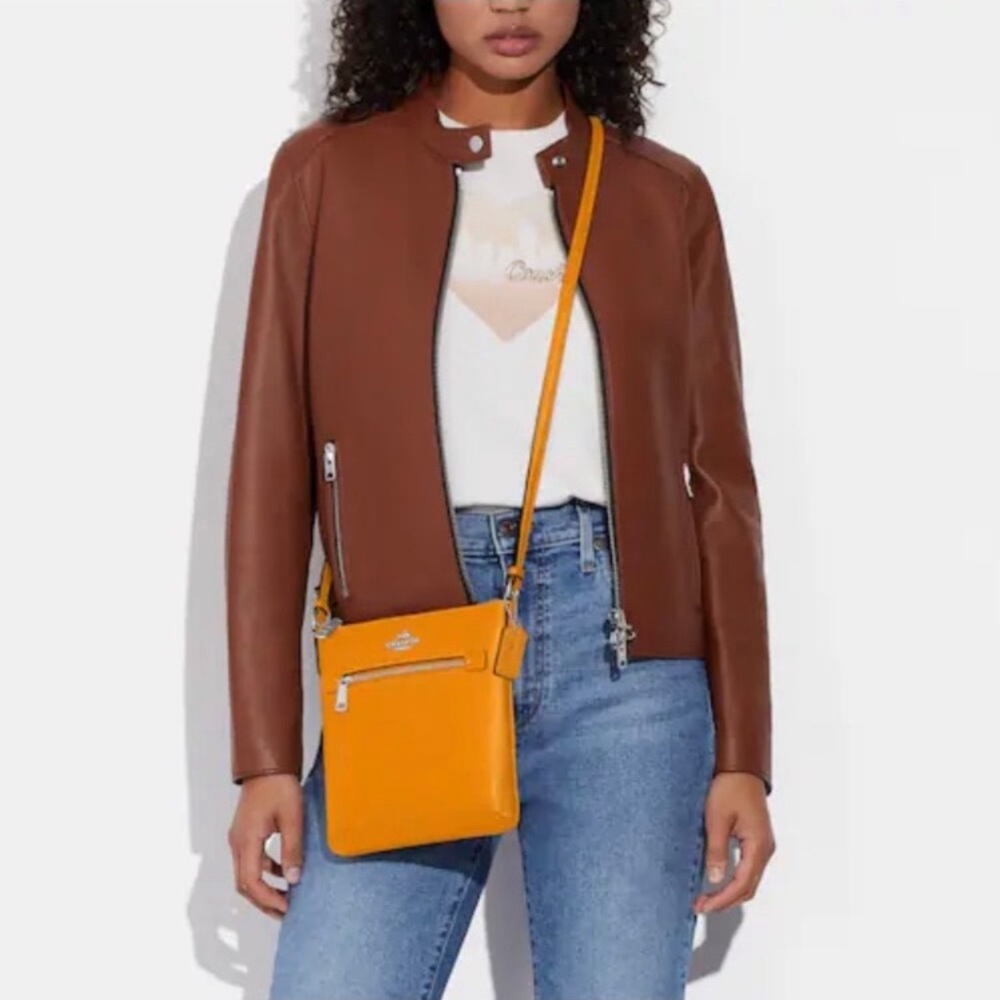 Coach 
Crossbody Bag Tan/ tangerine leather with sleek design